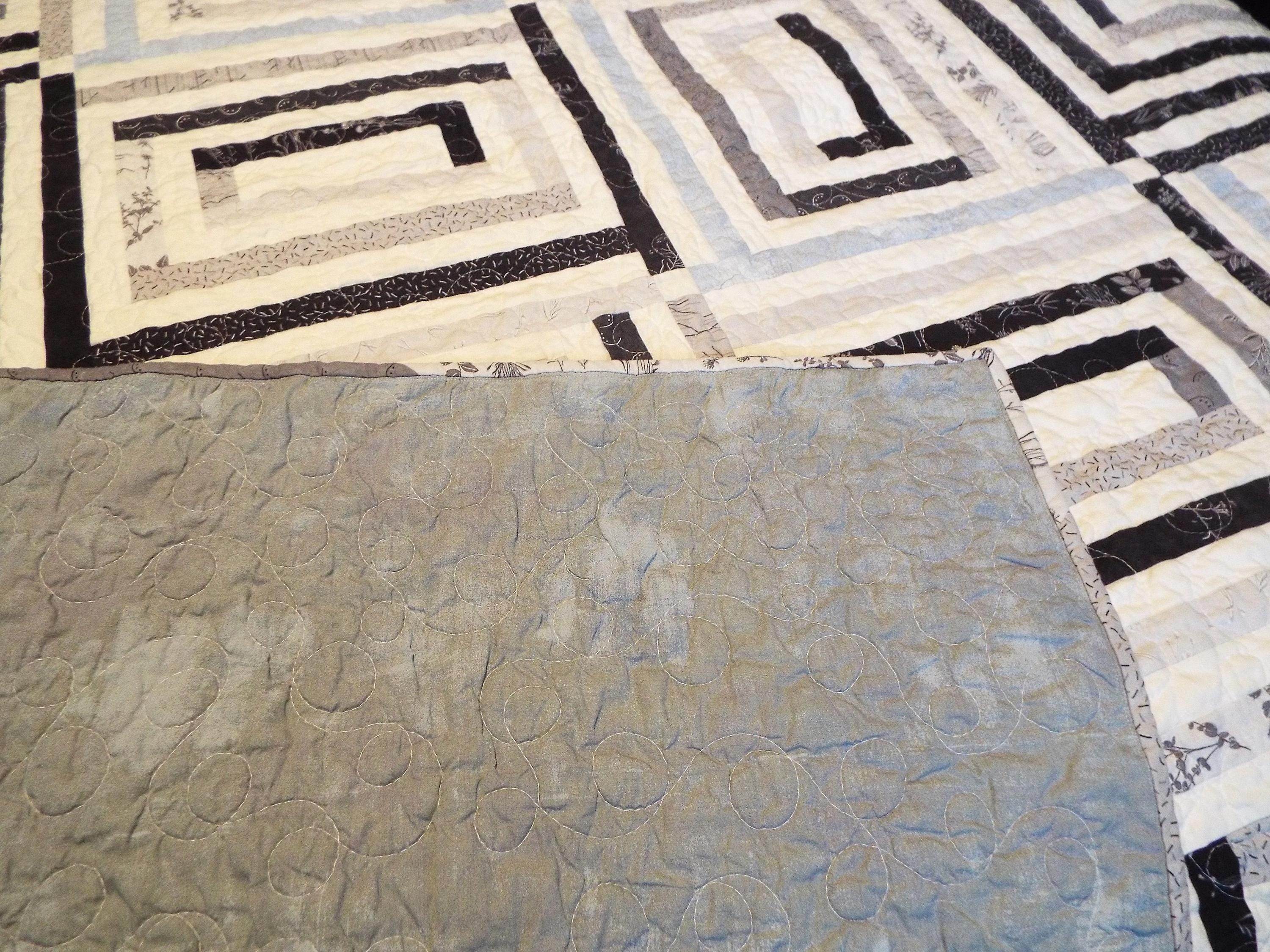 Detail shot with corner flipped up to show backing and quilt top together