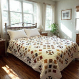 Adamstown quilt displayed on a bed in an airy bedroom with wooden floors and dressers