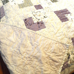 Corner flipped over to show backing of handmade twin quilt