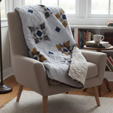 Celestial Cozy Throw shown draped over a chair in a reading nook