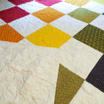handmade rainbow queen quilt with backing flipped over