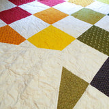 handmade rainbow queen quilt with backing flipped over