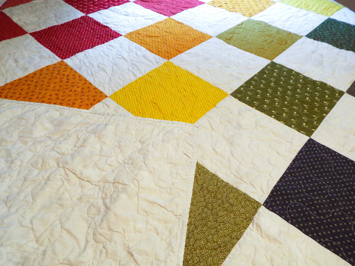 handmade rainbow queen quilt with backing flipped over