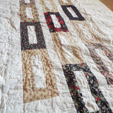 Angled flat lay of elegant minimal holiday quilt