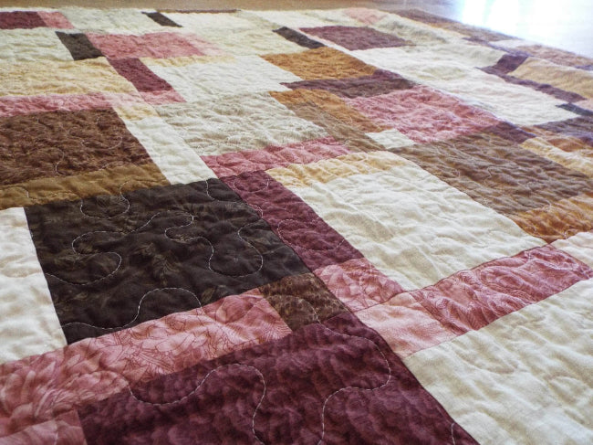 Angled shot of rose gold handmade quilt
