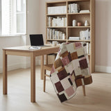 Quilt on the back of a wooden chair in a minimally styled office