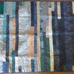 Blue striped quilt flat lay showing entire quilt