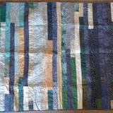 Blue striped quilt flat lay showing entire quilt