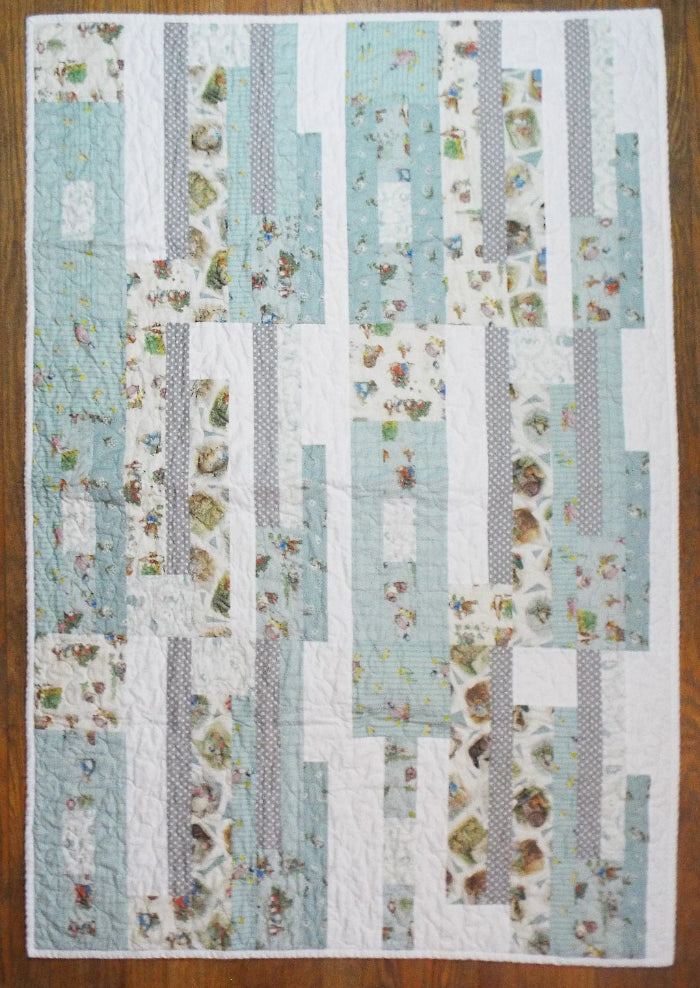 Twilight Tails blue baby quilt flat lay