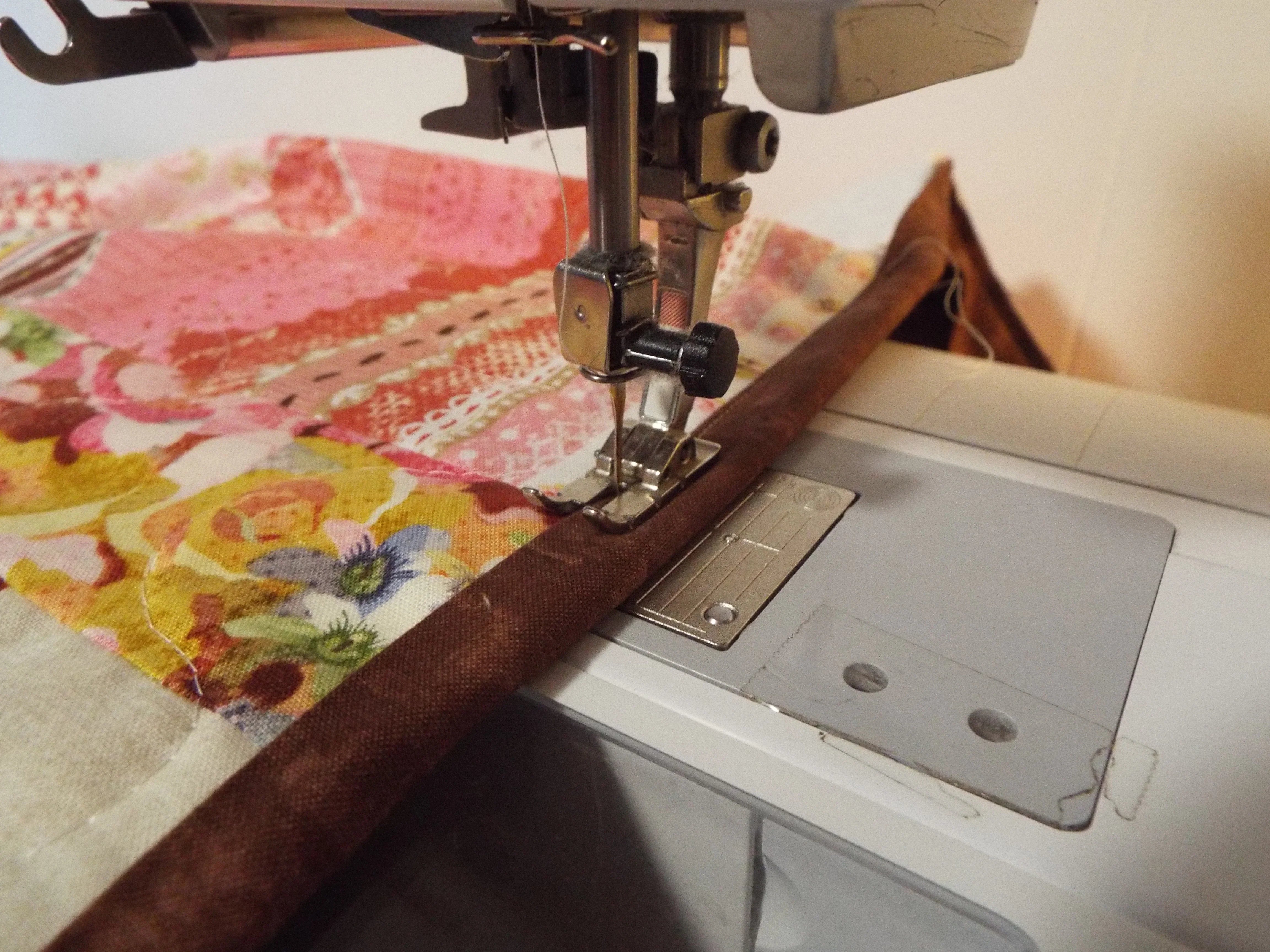 hearts and flowers throw on sewing machine getting binding finished
