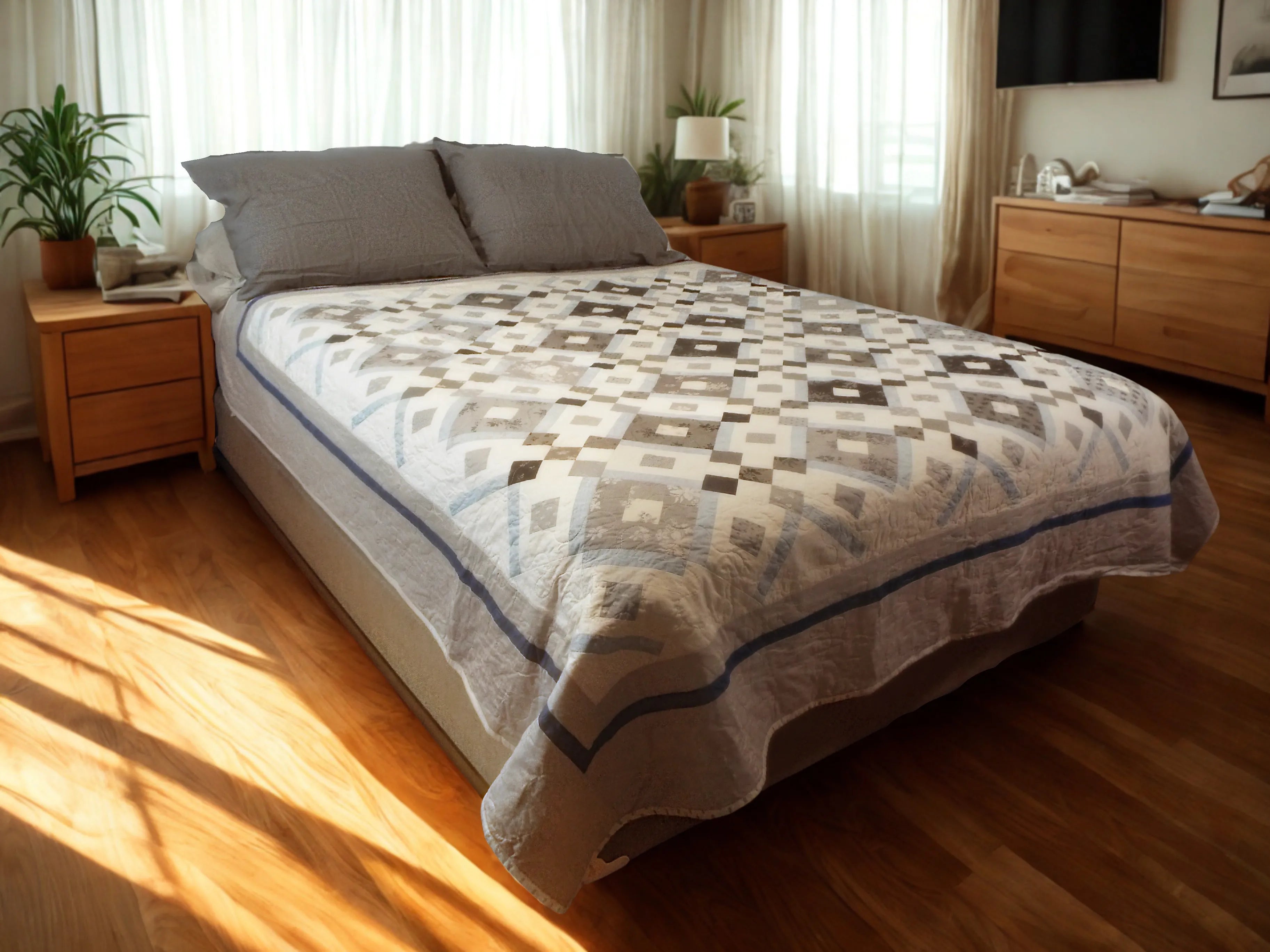 Handmade black and white quilt shown on a queen sized bed in a modern minimal bedroom