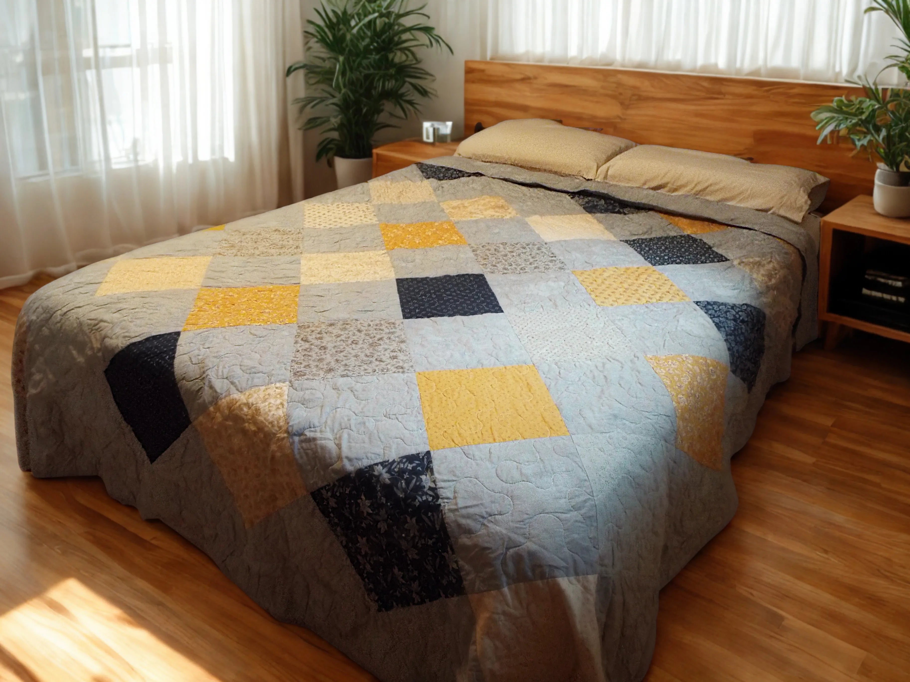 Somerset Blues Queen quilt spread over a bed with a wooden headboard in a minimally decorated room