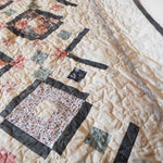Close up of stitching on handmade twin floral quilt