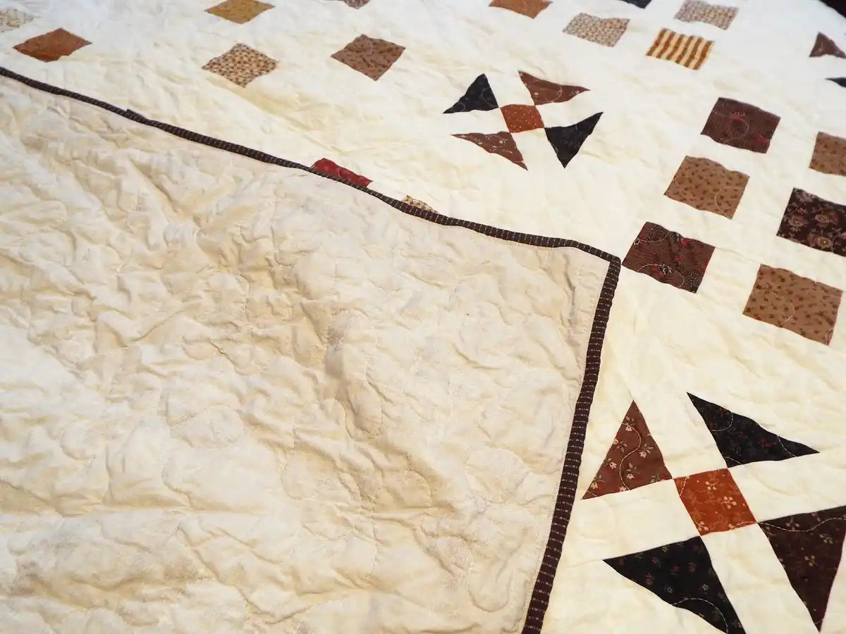 Adamstown Queen shown with the corner flipped to see backing and quilt top together.