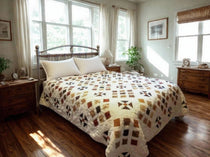 Adamstown quilt displayed on a bed in an airy bedroom with wooden floors and dressers