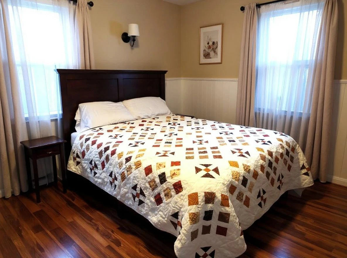 Adamstown handmade queen quilt shown on a bed with a dark wooden headboard in a minimal bedroom