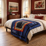A styled bedroom scene showing a bed dressed in a cream bedding set with Air Force Airman Throw Quilt. The room has dark red walls, wood floors, a wooden dresser, and framed floral paintings.