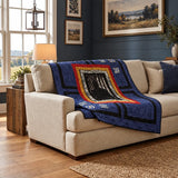 Air Force Airman Throw Quilt shown on a cream sofa in a simply decorated living room.