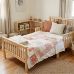 Quilt shown on child's bed in neutral bedroom