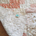Quilt shown with corner flipped to show backing.