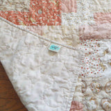 Quilt shown with corner flipped to show backing.
