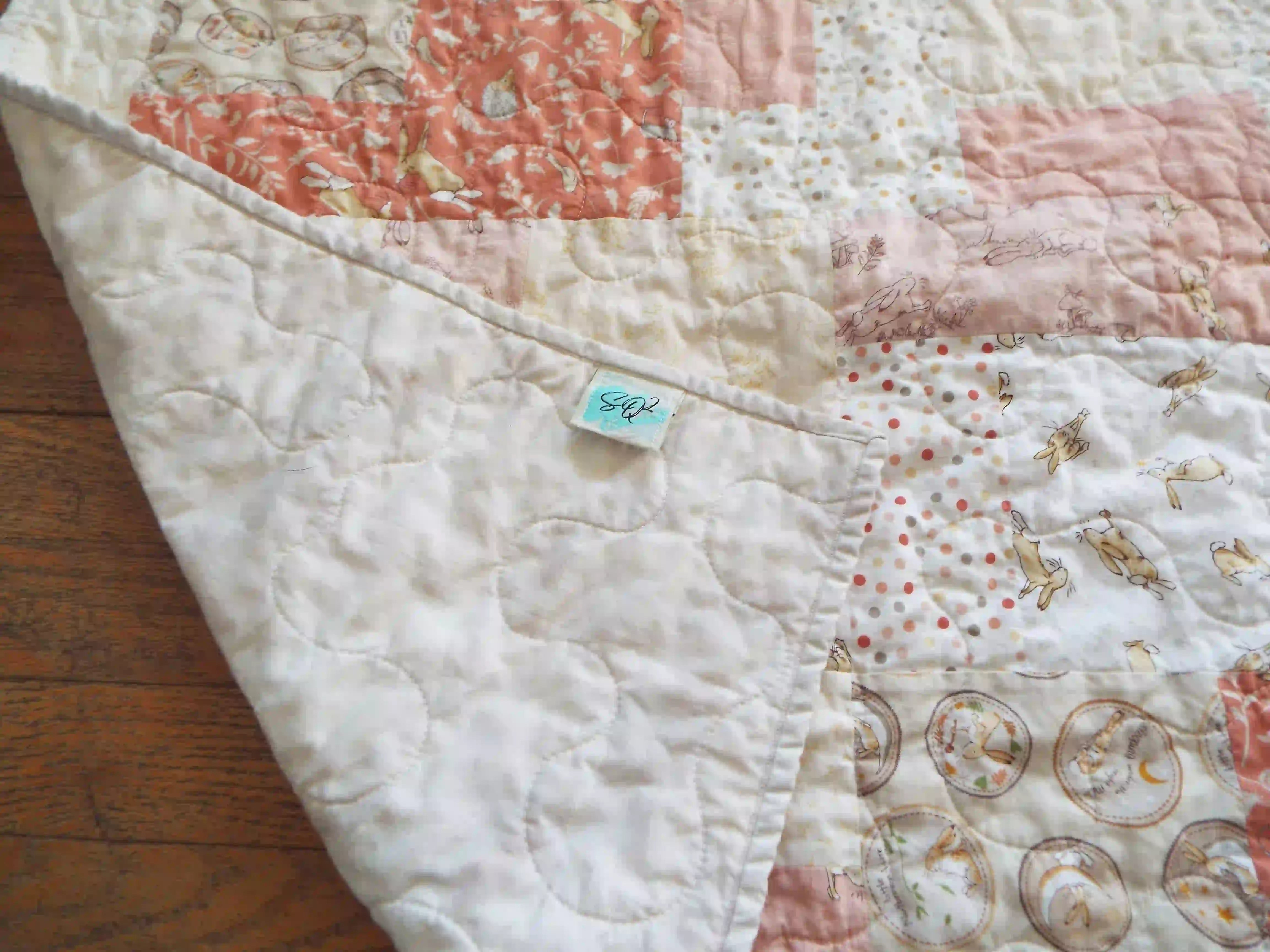 Quilt shown with corner flipped to show backing.