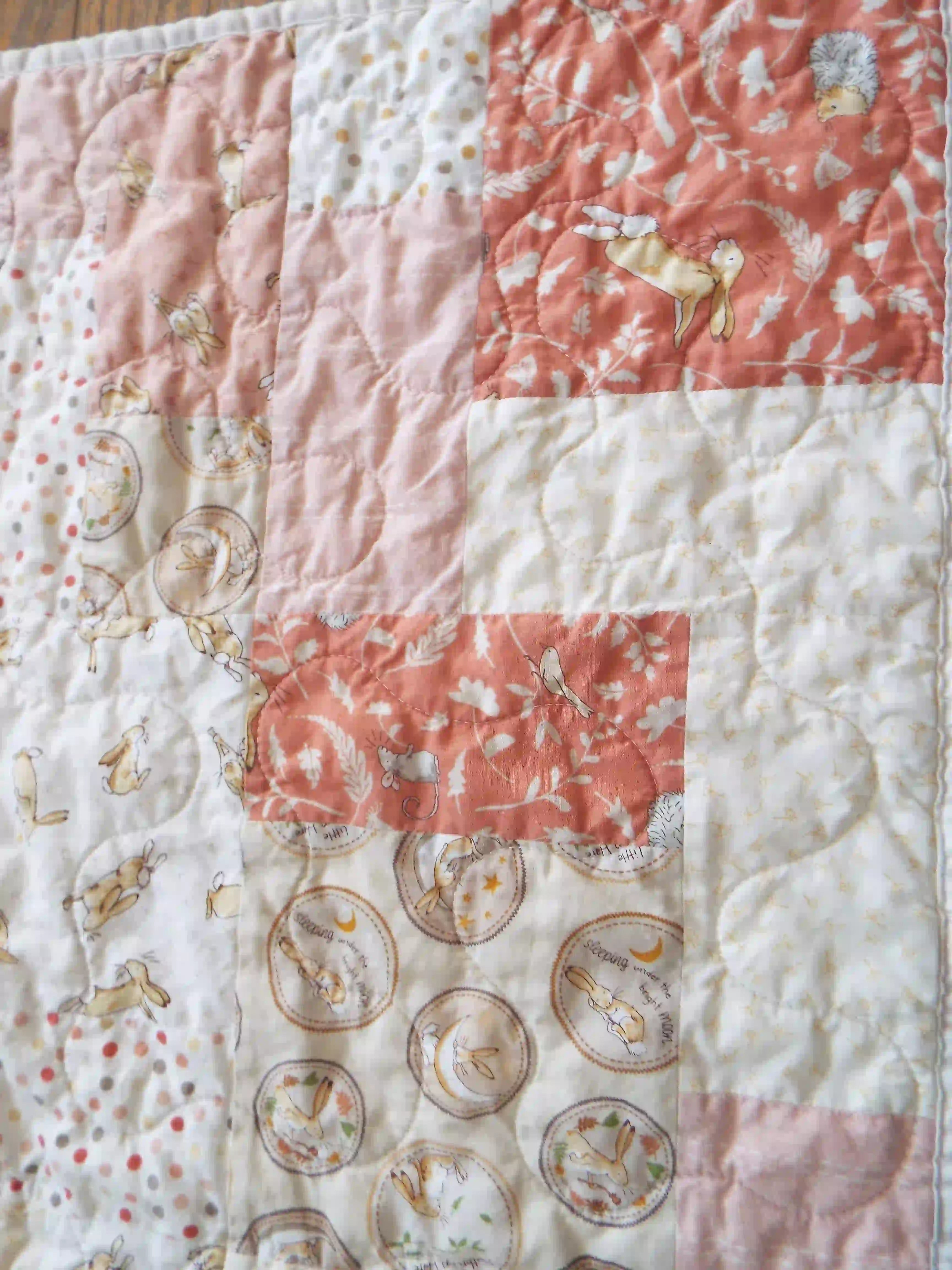 Detail shot of quilt showing close up of fabrics and stitching