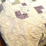 Corner flipped over to show backing of handmade twin quilt