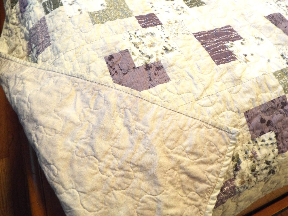 Corner flipped over to show backing of handmade twin quilt