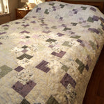 Twin-sized handmade quilt close view in a minimal bedroom