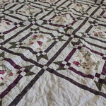 Angled lay of Avonlea Garden Twin Quilt showing fabric and design detail.