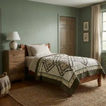 Avonlea Garden Twin Quilt shown in simple sage room with wooden furniture.