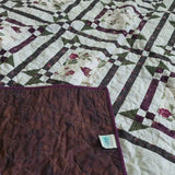 Corner flipped over on Avonlea Garden Twin Quilt showing backing against quilt top.