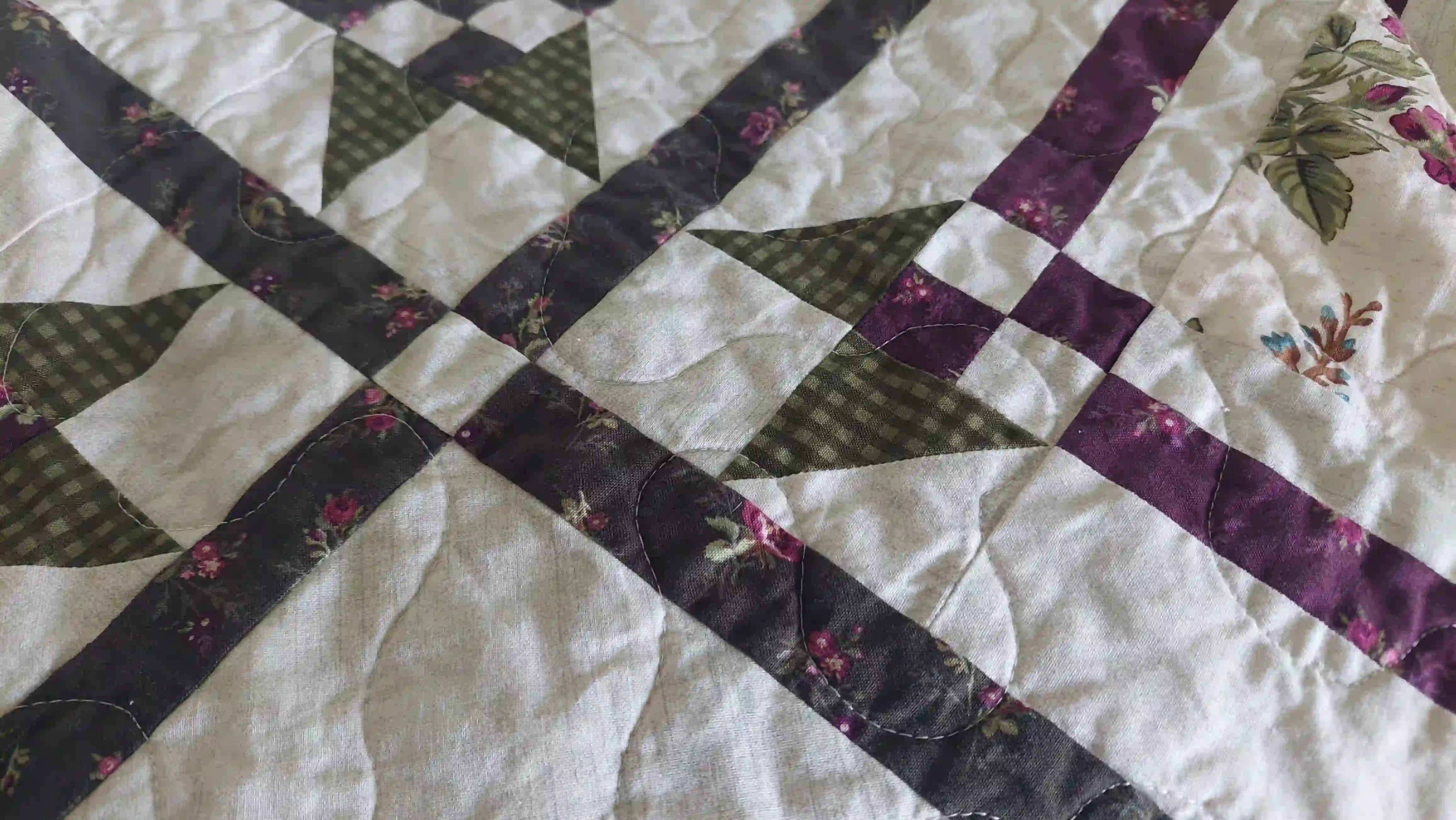 Detail shot of Avonlea Garden Twin Quilt showing quilt stitching and piecing detail.
