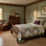 Avonlea Garden Twin Quilt shown in a traditional farmhouse inspired room with leather chair and wooden furniture.