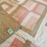 Blushing Pathways Baby Quilt shown with corner flipped over to see backing detail.