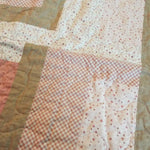 Detail of Blushing Pathways Baby Quilt showing quilt stitching.