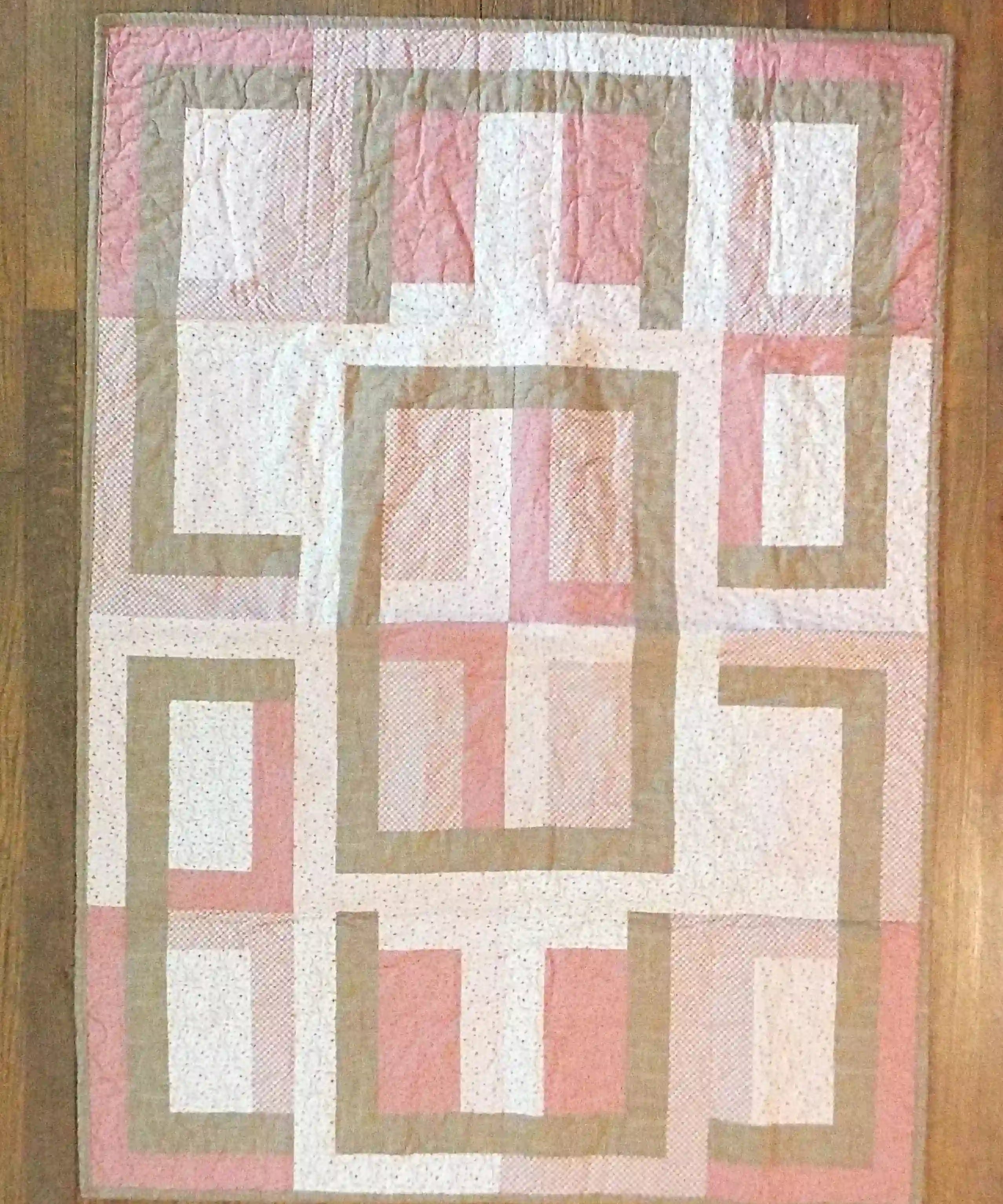 Flat lay of Blushing Pathways Baby Quilt showing entire pattern.