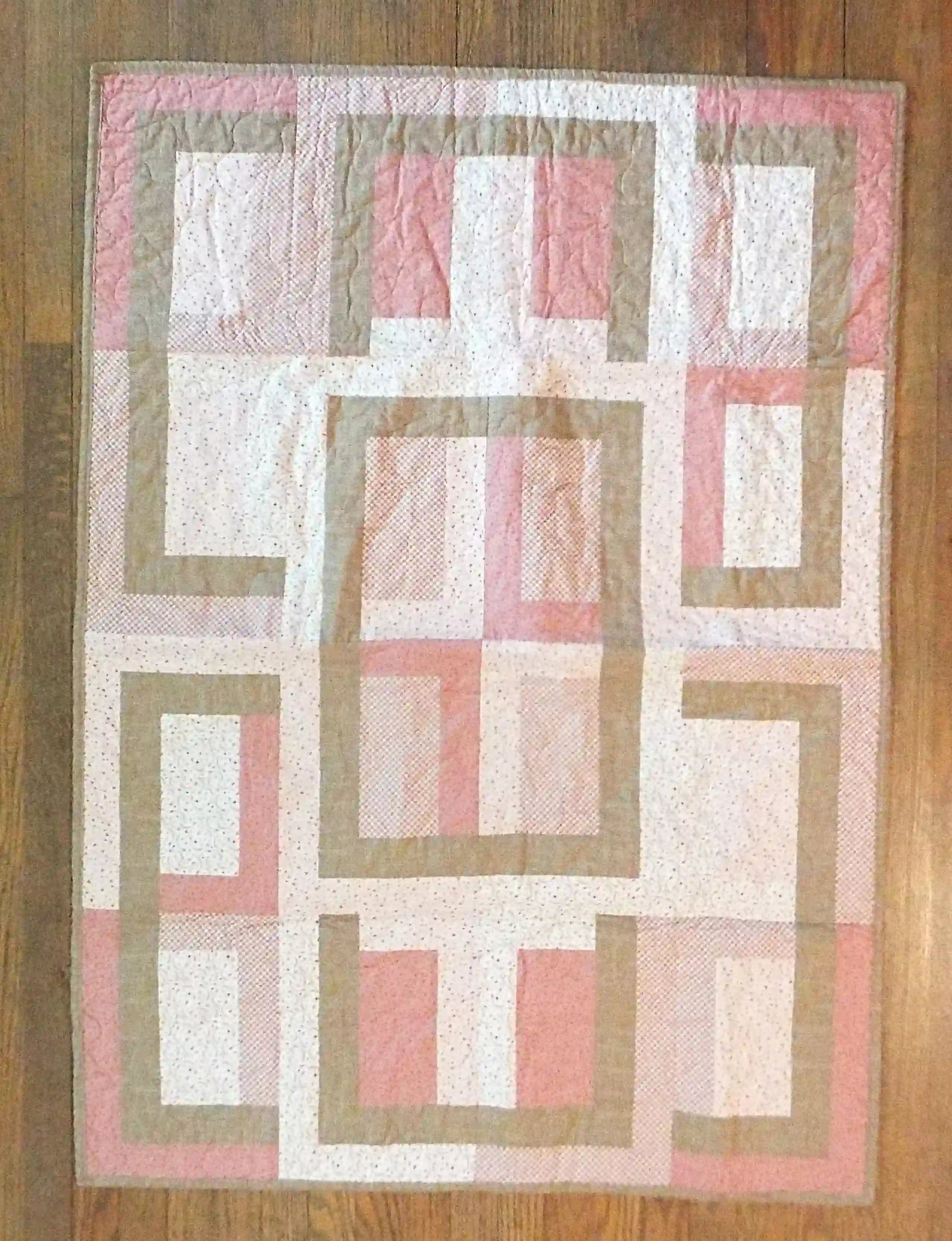 Flat lay of Blushing Pathways Baby Quilt showing entire pattern.
