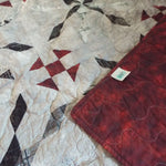 Cartographer's Notes Queen Quilt shown with corner flipped over to see backing and stitching detail.