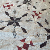Detail showing some of the fabrics and the quilt stitching for Cartographer's Notes Queen Quilt.