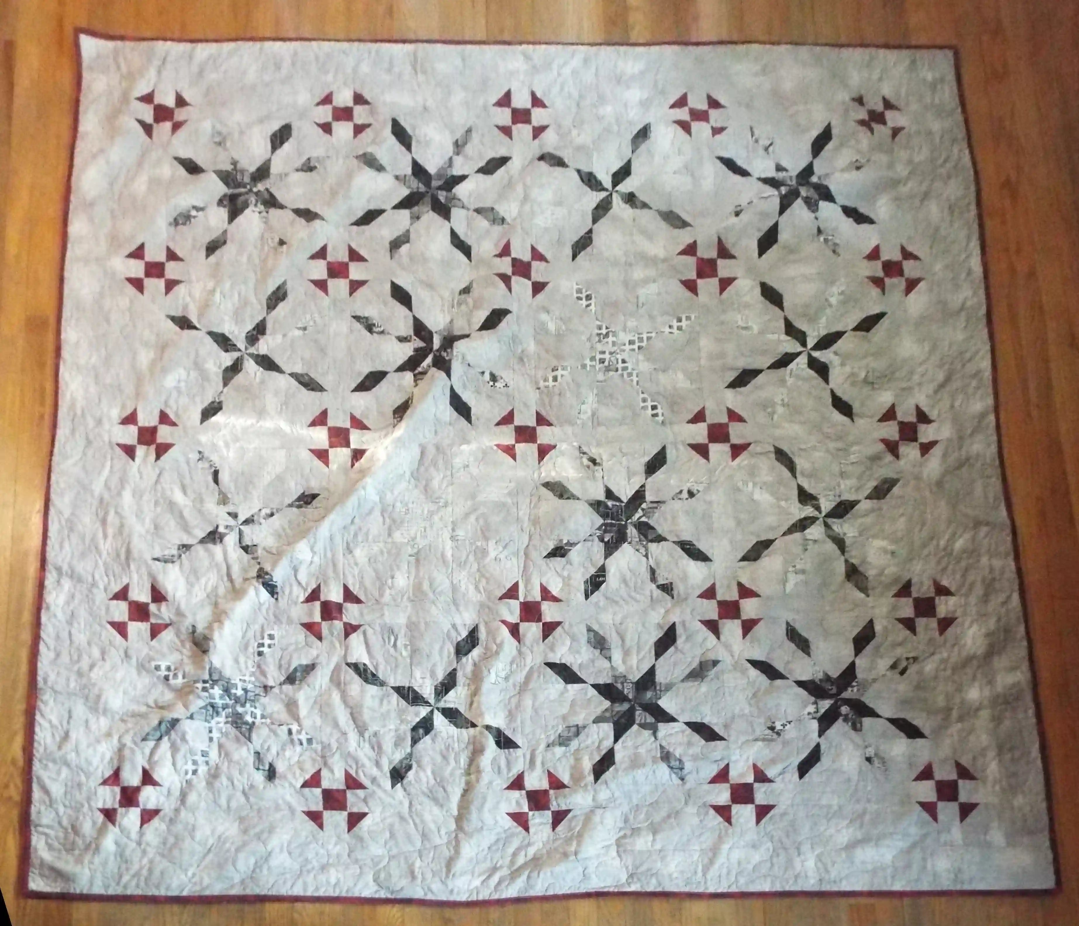 Flat lay of Cartographer's Notes Queen Quilt showing entire pattern.