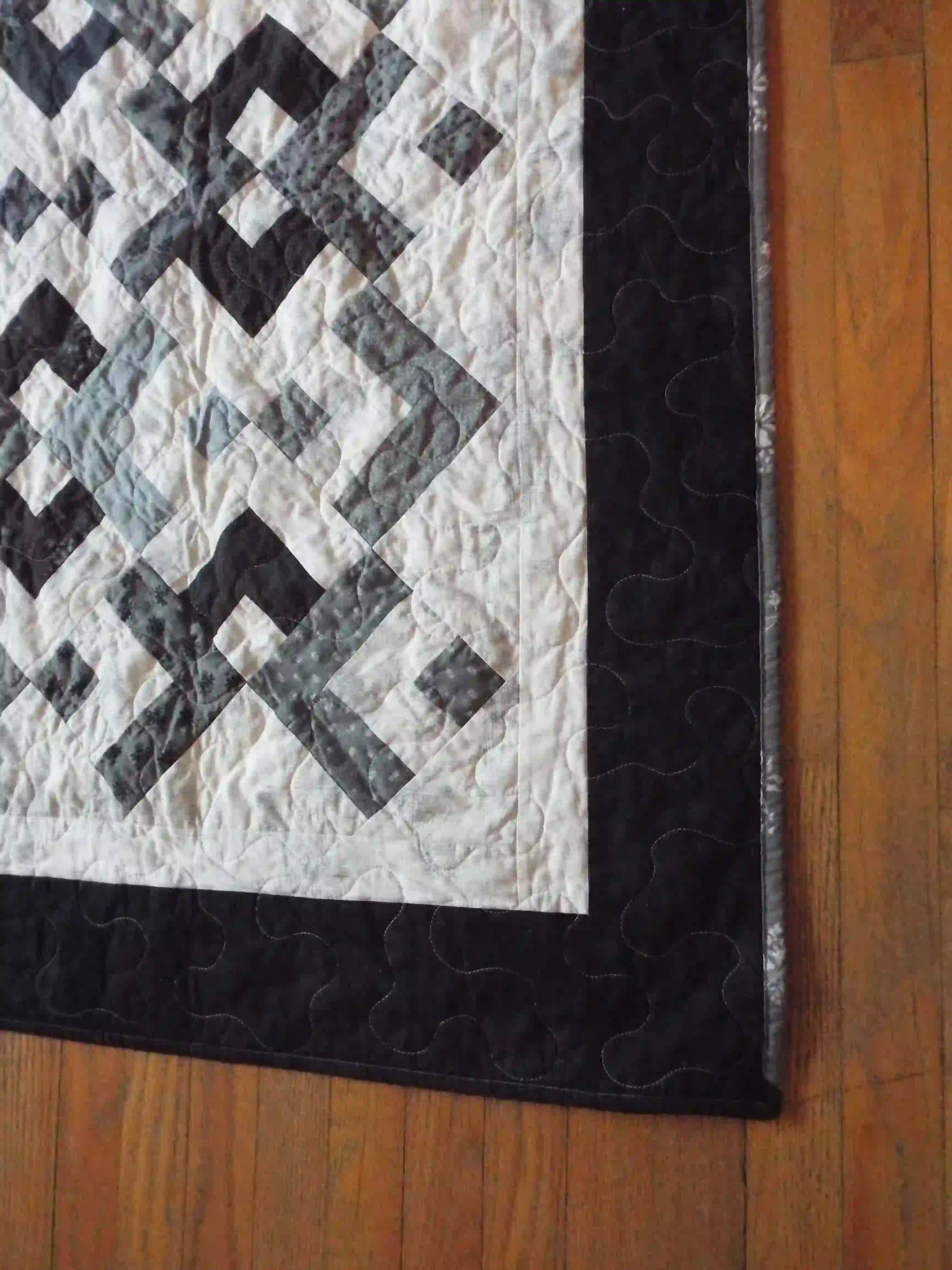 Detail shot of the quilt showing binding and stitching