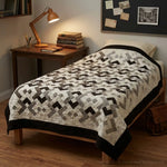 Twin quilt shown on the bed of a dorm room