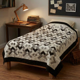 Twin quilt shown on the bed of a dorm room