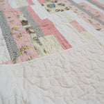 Corner flipped showing backing on Daisy Dreams pink baby quilt