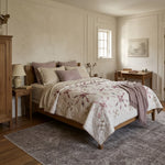 Scarlet Correspondence Queen Quilt shown in a neutral room with a gray rug.