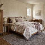 Scarlet Correspondence Queen Quilt shown in a neutral room with a gray rug.