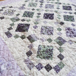 Angled lay of Evening Lattice lap quilt