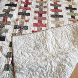 Handmade Chic Holiday throw with corner flipped up to show backing with quilt top